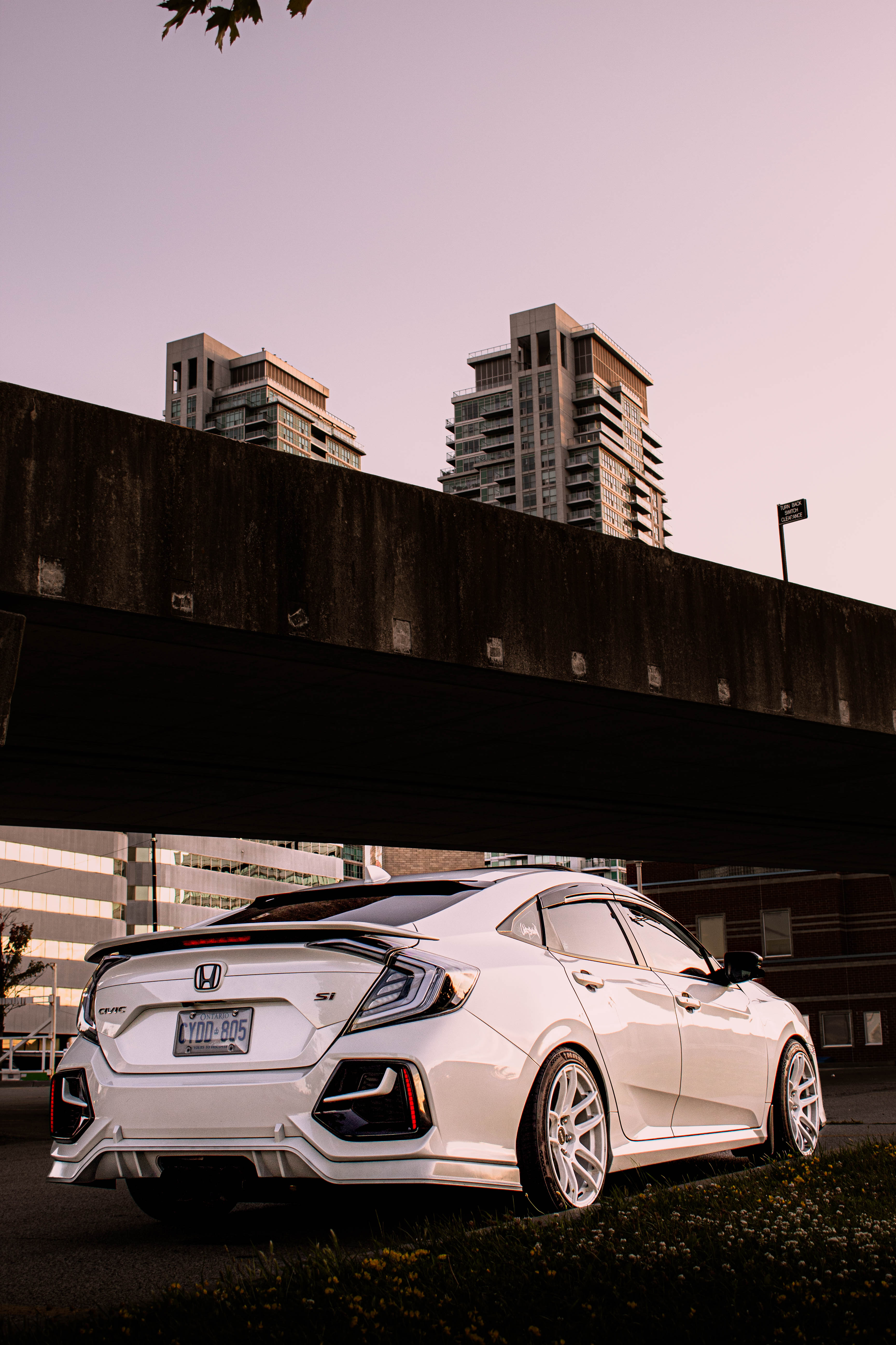 White Civic Si parked under an overpass
